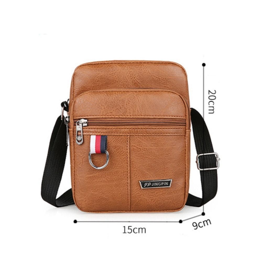 Braune Ledertasche im Sling-Bag-Stil mit schwarzem Gurt und silbernen Reißverschluss-Verzierungen, entworfen als legere Umhängetasche im Schulter-Design, als Crossbody-Tasche für Herren