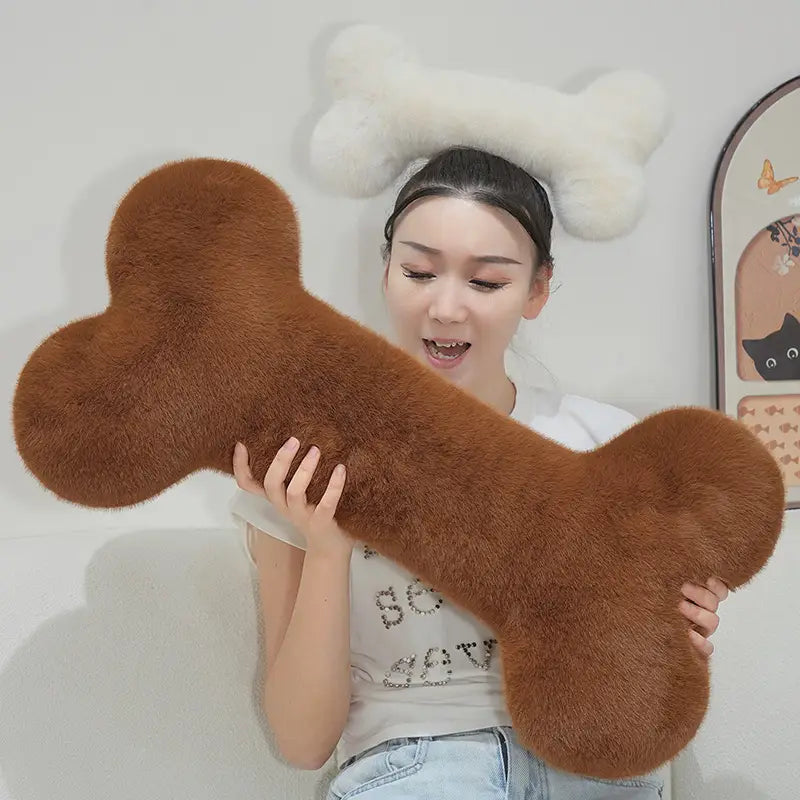 a brown faux fur bone shape plush pillow with a soft fluffy texture designed as a kawaii bone shape soft nap cushion
