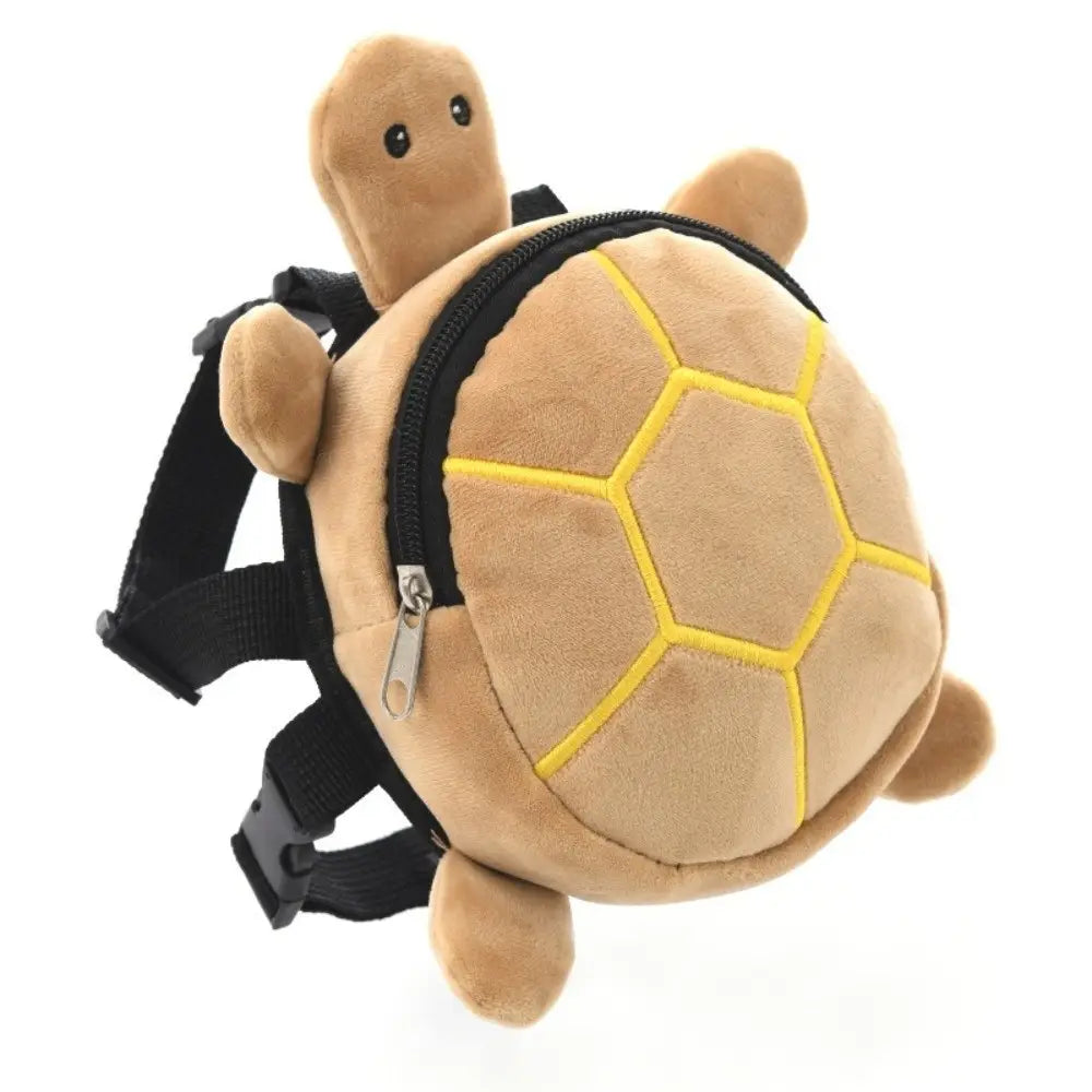 tan plush turtle shape dog backpack with yellow stitched shell patterns and black adjustable straps designed as a toddler backpack and pet carrier