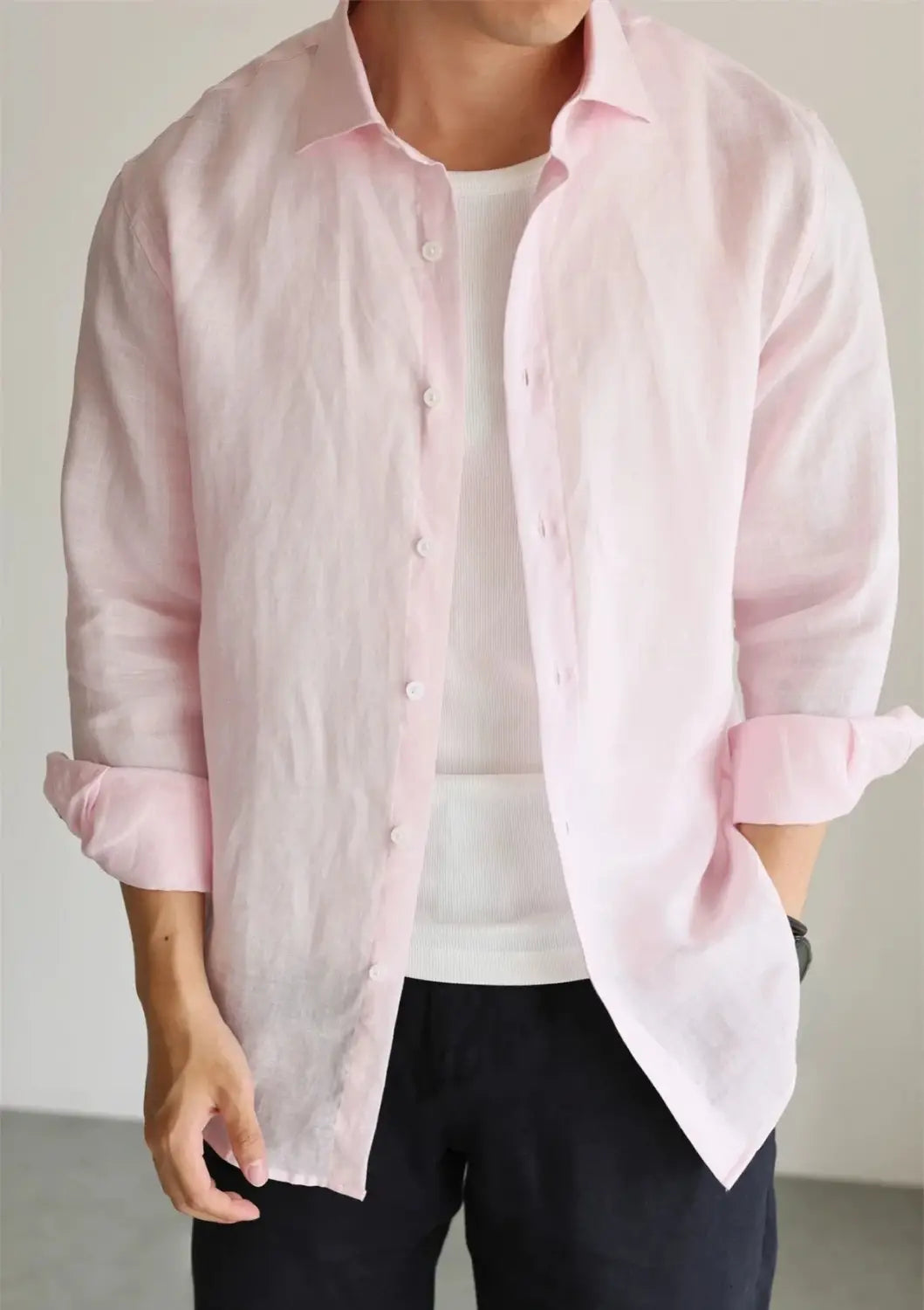 A soft pink cotton linen casual button down shirt for men featuring a classic collar and rolled sleeves.