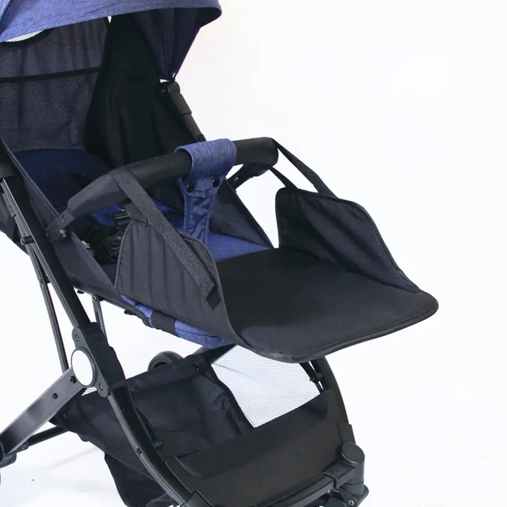 black and navy blue universal stroller extension footrest with a foldable tray attached to the handlebar for infant use