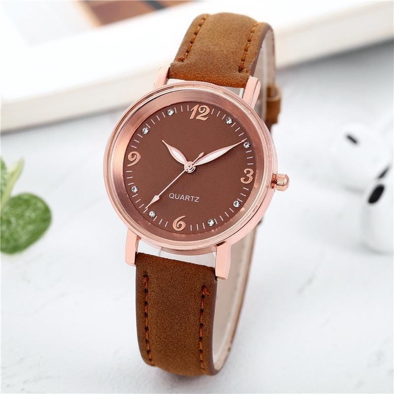 women quartz watch with rose gold-toned dial and brown leather band featuring small crystal markers