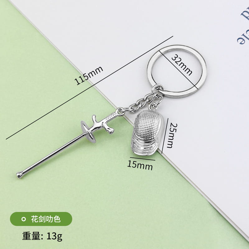 Silver-colored metallic fencing keychain featuring a detailed sword and an ornate textured glove charm for sports jewelry.