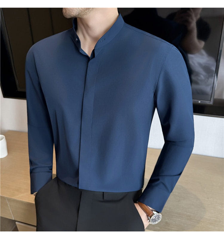 A sleek navy blue slim fit men dress shirt with a modern stand collar and subtle vertical seam detailing designed to ensure the correct size for formal occasions
