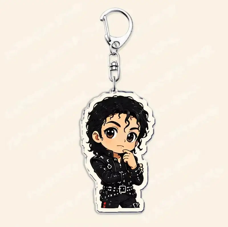 michael jackson chibi acrylic keychain featuring a cartoon depiction of michael jackson in his black leather outfit with studded details and curly hair attached to a silver-toned metal clip.