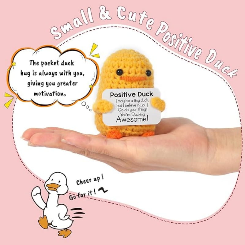 Yellow crocheted graduation duck 2025 gift with black bead eyes and orange beak holding a white card reading positive duck.