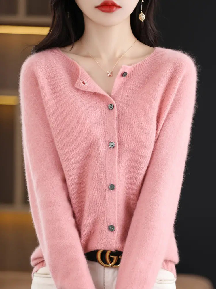 A soft pink long-sleeved merino wool cardigan for women with a button-front closure and subtle texture.
