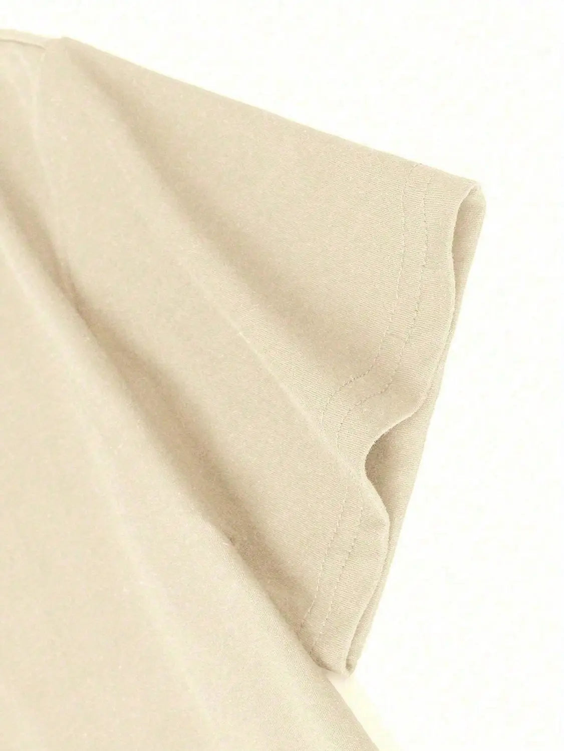 Beige cotton graphic print oversized men short sleeve t shirt showing sleeve with neatly stitched hem.