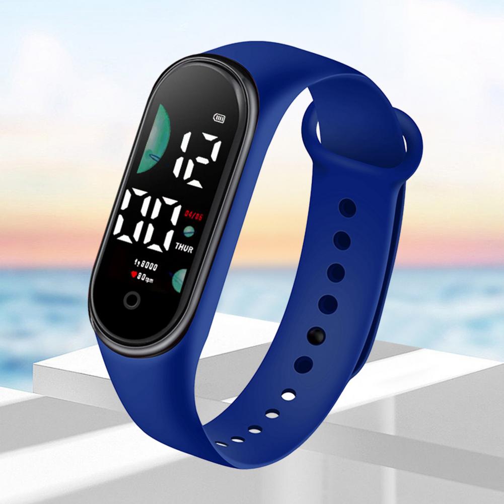 Blue silicone electronic watch with large font screen and black digital display showing time date and step count designed for sports use.