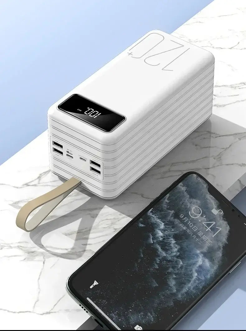 white rectangular portable power bank with 120000mah capacity and 66w fast charging featuring a digital display multiple usb ports and a beige wrist strap.