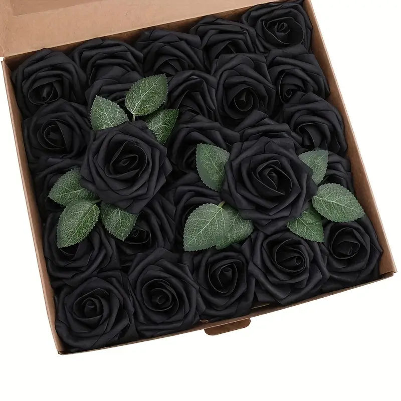 Une boîte de roses de fleurs artificielles noires, avec des feuilles vertes et des tiges, à des fins de décoration.