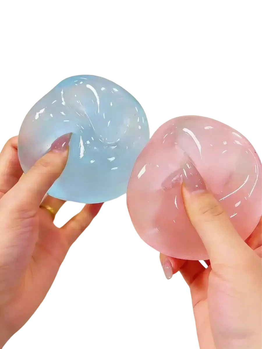 Two translucent gel-like blue and pink moldable slow rebound stress balls held against a white frosted cake
