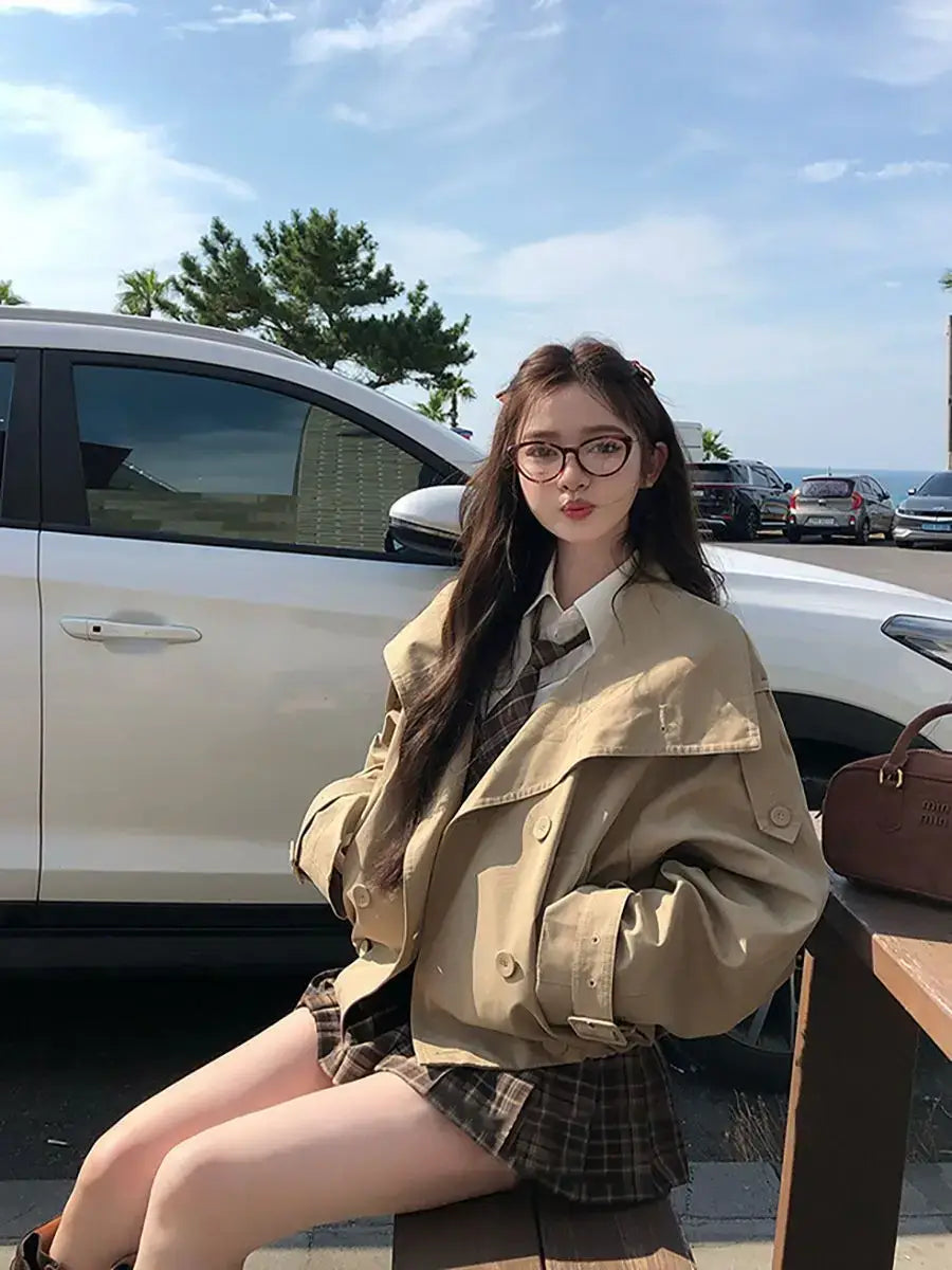 tan trench coat with classic double breasted design and buttoned cuffs featured in a korean trench coat utility jacket style