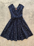 A navy blue sky full of stars greta vintage cotton dress with v-neckline short sleeves and space-themed print