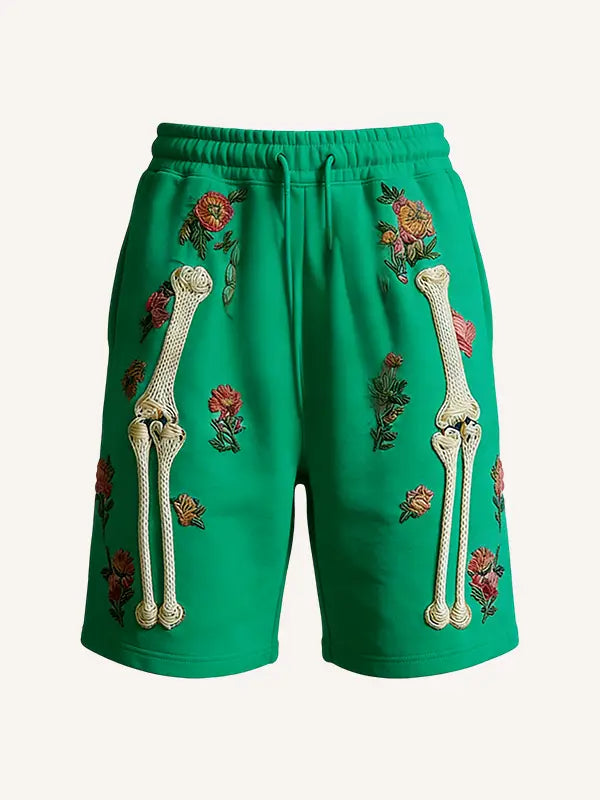 Vibrant green polyester men sweat shorts featuring embroidered white bone designs and floral patterns called skeleton floral sweatshorts.