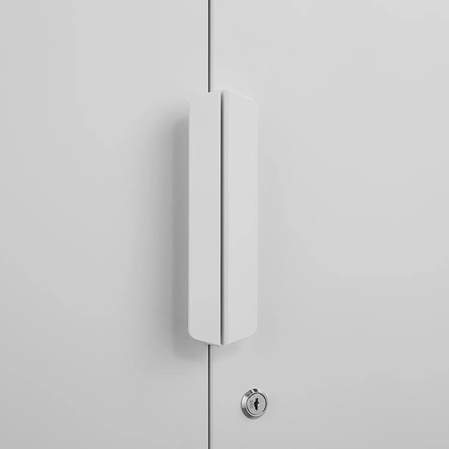 White minimalist cabinet handle with a sleek modern design on a steel file cabinet 70 inch two door lockable white storage unit.