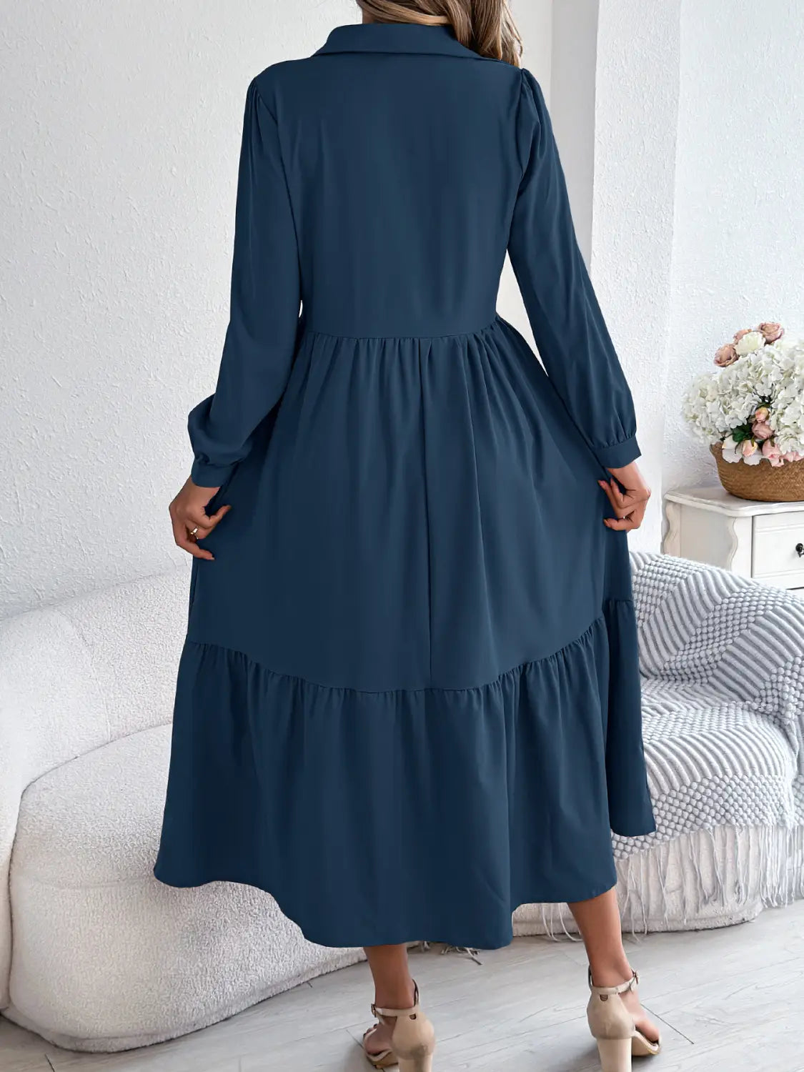 A navy blue long sleeve tiered midi dress with a collar and ruffled hem suitable for womens formal or casual wear.