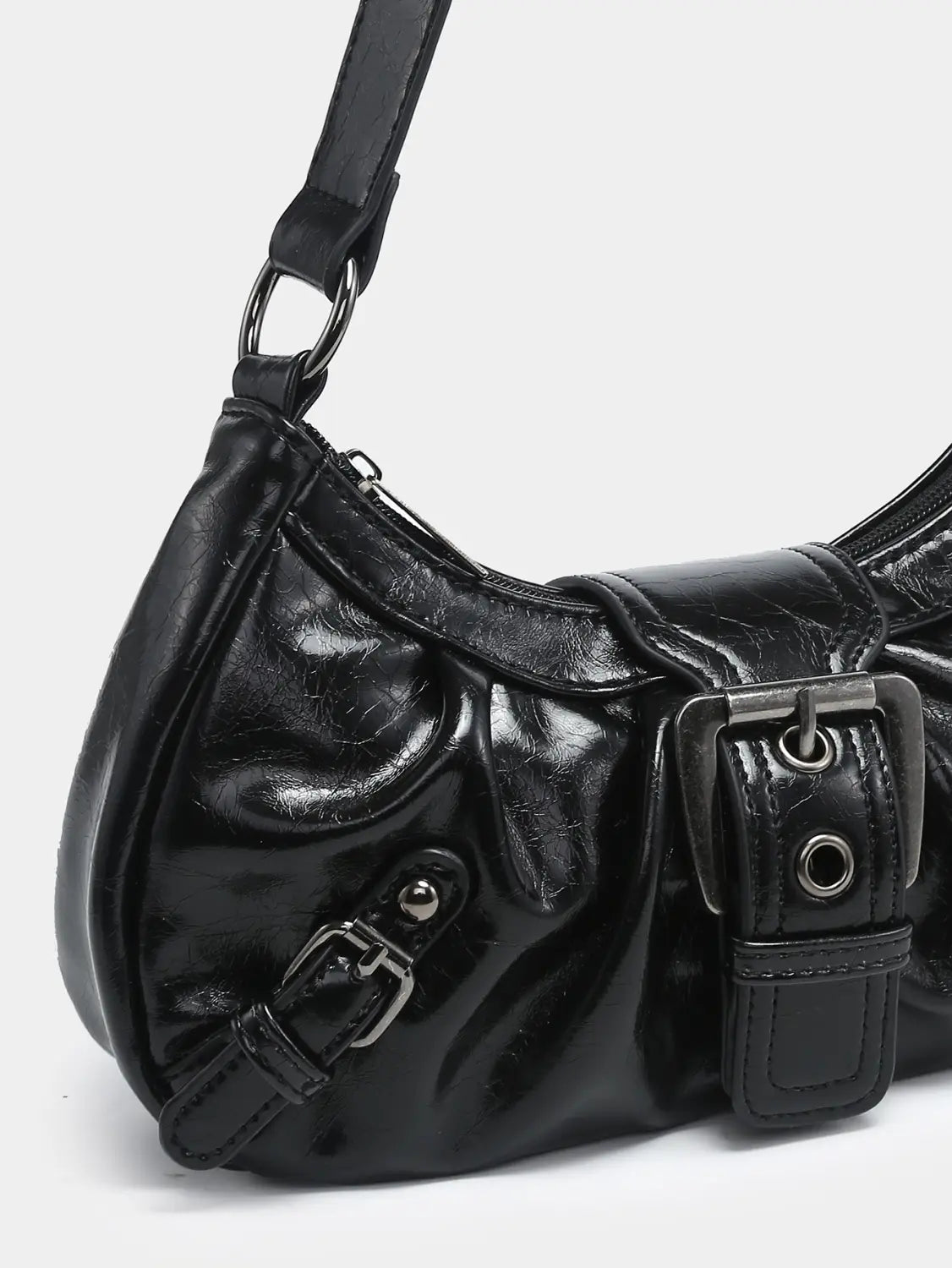 Black patent leather vintage shoulder bag with glossy finish and multiple silver-toned buckle details.