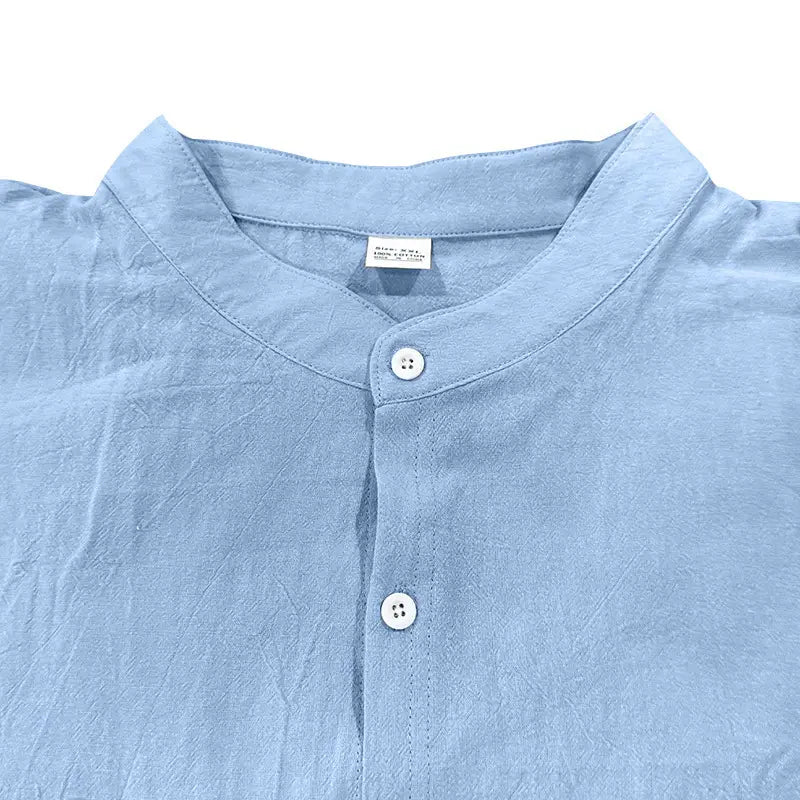 Men’s casual linen stand collar long sleeve shirt in light blue with subtle texture and white buttons.