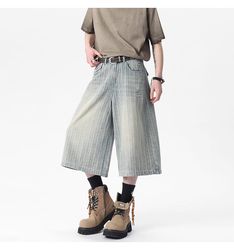 Striped denim capri shorts in wide-leg style with a faded vertical striped pattern in light blue and white.
