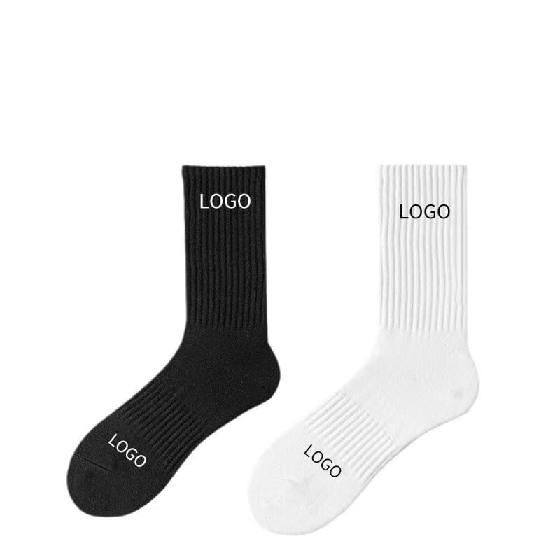 A pair of custom crew socks unisex cotton mid calf socks featuring ribbed texture in black and white with subtle logo printed in contrasting color on the cuff and toe.