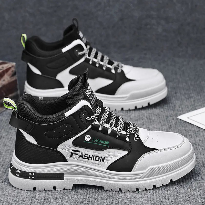 Men’s high-top chunky elevator sneakers xb13 in black and white with a chunky sole featuring fashion branding in green and silver lettering on the side.