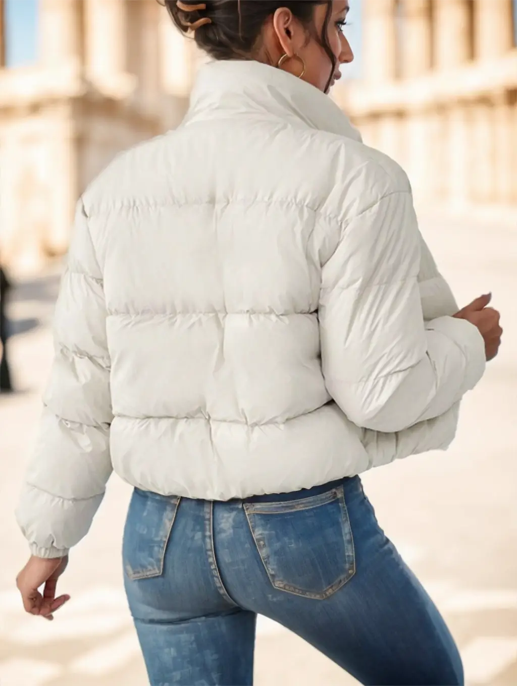 A white reversible fleece puffer jacket with a high collar and quilted design.