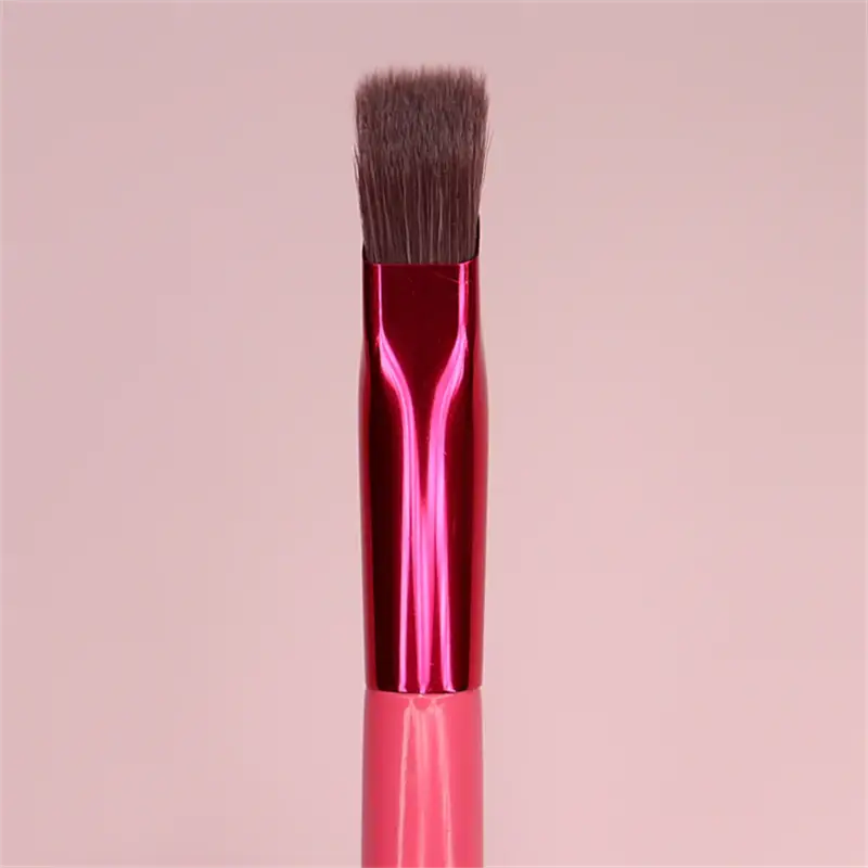 Angled eyebrow and concealer makeup brush featuring vibrant pink and magenta dense dark brown bristles with a sleek metallic handle.