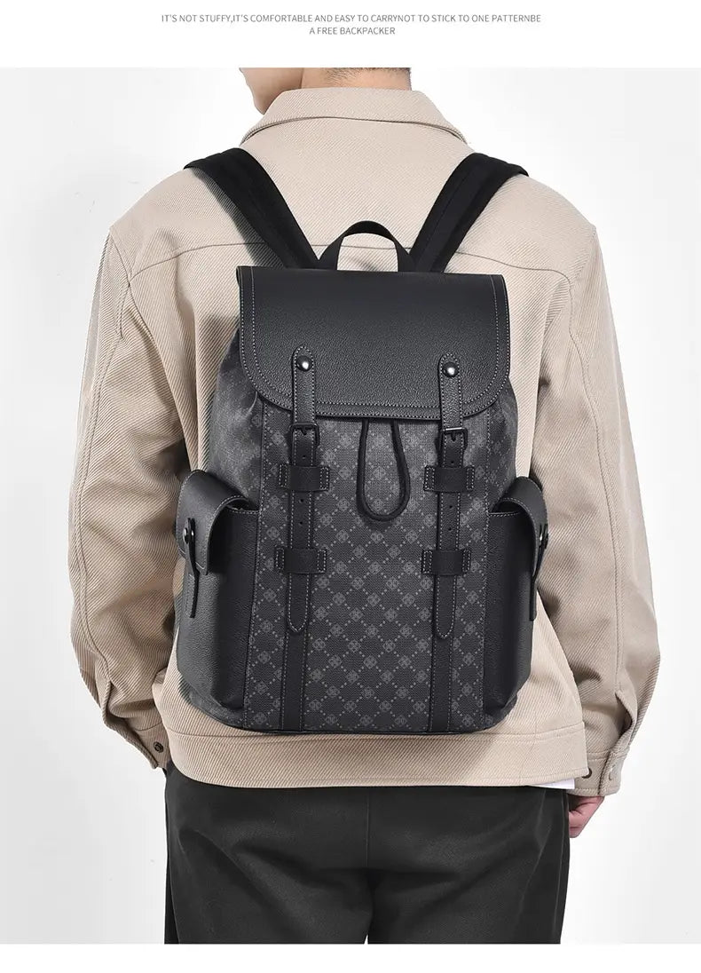 Men’s leather business travel backpack in black with subtle geometric pattern and sturdy leather straps featuring a laptop sleeve.