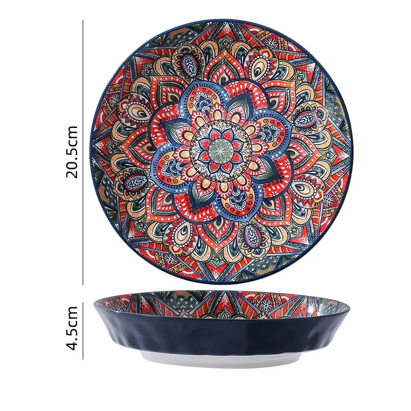 A vibrant hand-painted ceramic mandala serving bowl with an intricate design in reds blues and gold tones and a deep navy rim holding 400ml.
