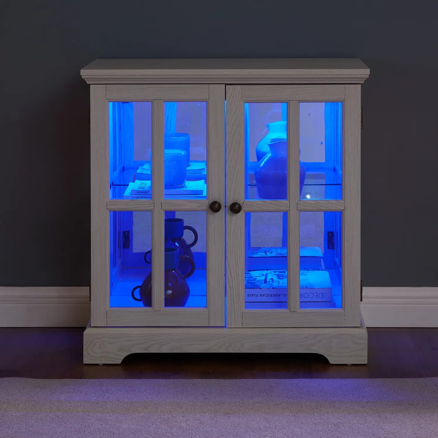 led curio display cabinet white wooden with lattice glass doors and blue interior led illumination.