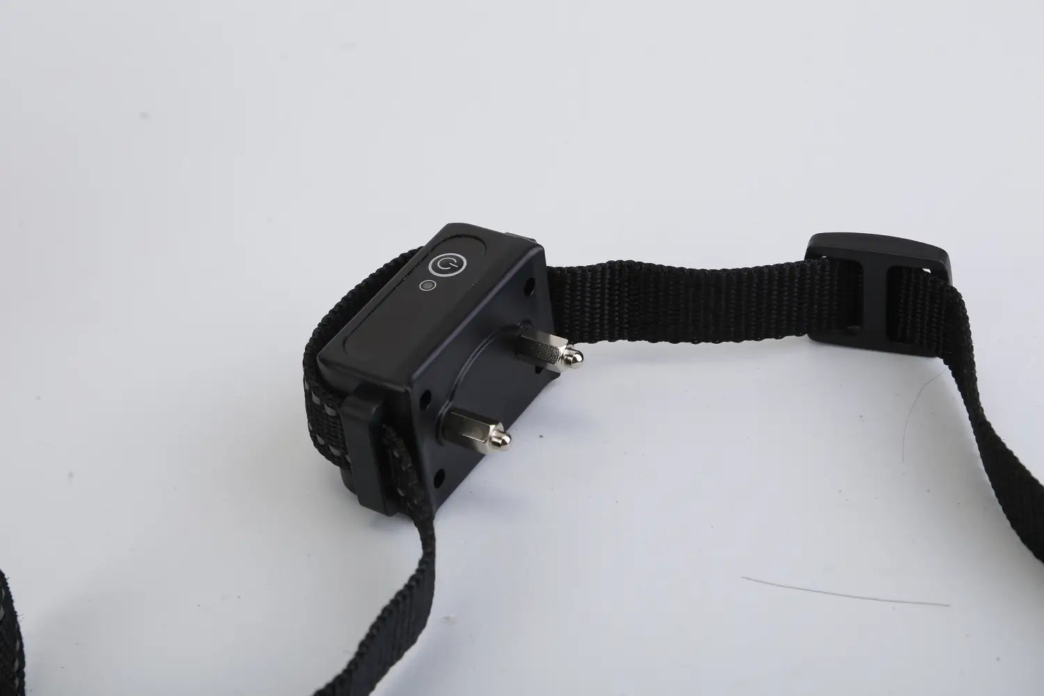 Black electronic dog training collar with adjustable strap and power button designed for 3280ft waterproof shock system use.