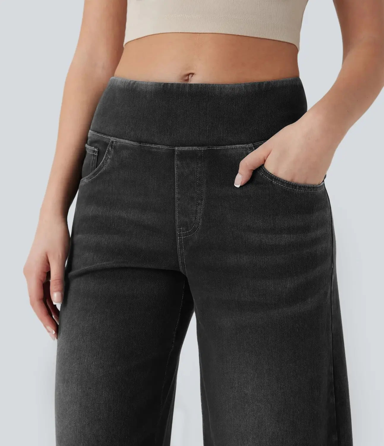 Black wide-leg stretchy high waisted jeans with a high-rise elastic waistband made of denim.