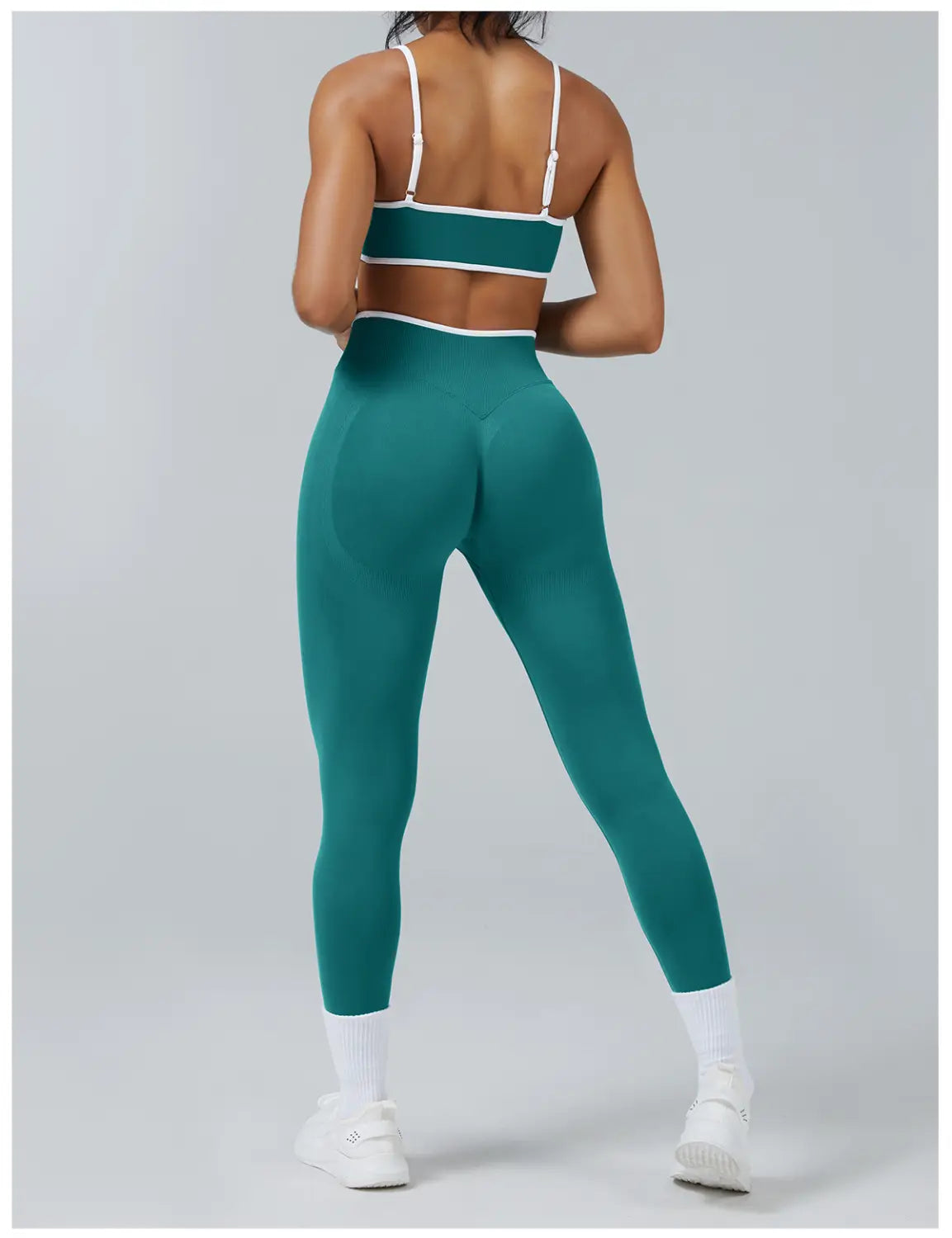 teal seamless high waist sports yoga leggings with white trim paired with matching sports bra designed for athletic use
