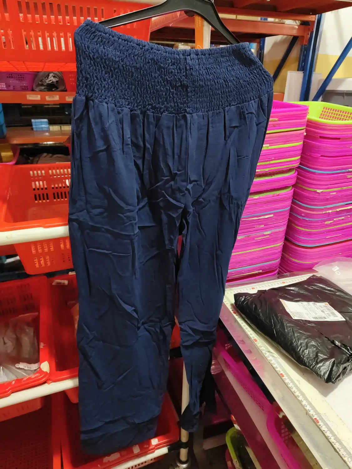 navy blue smocked wide leg pants for women featuring an elastic waist, relaxed fit, and subtle pleats along the legs in solid color high waist design.