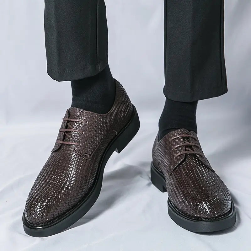 Men’s woven leather platform British dress shoe in black with lace-up design and solid rubber sole.