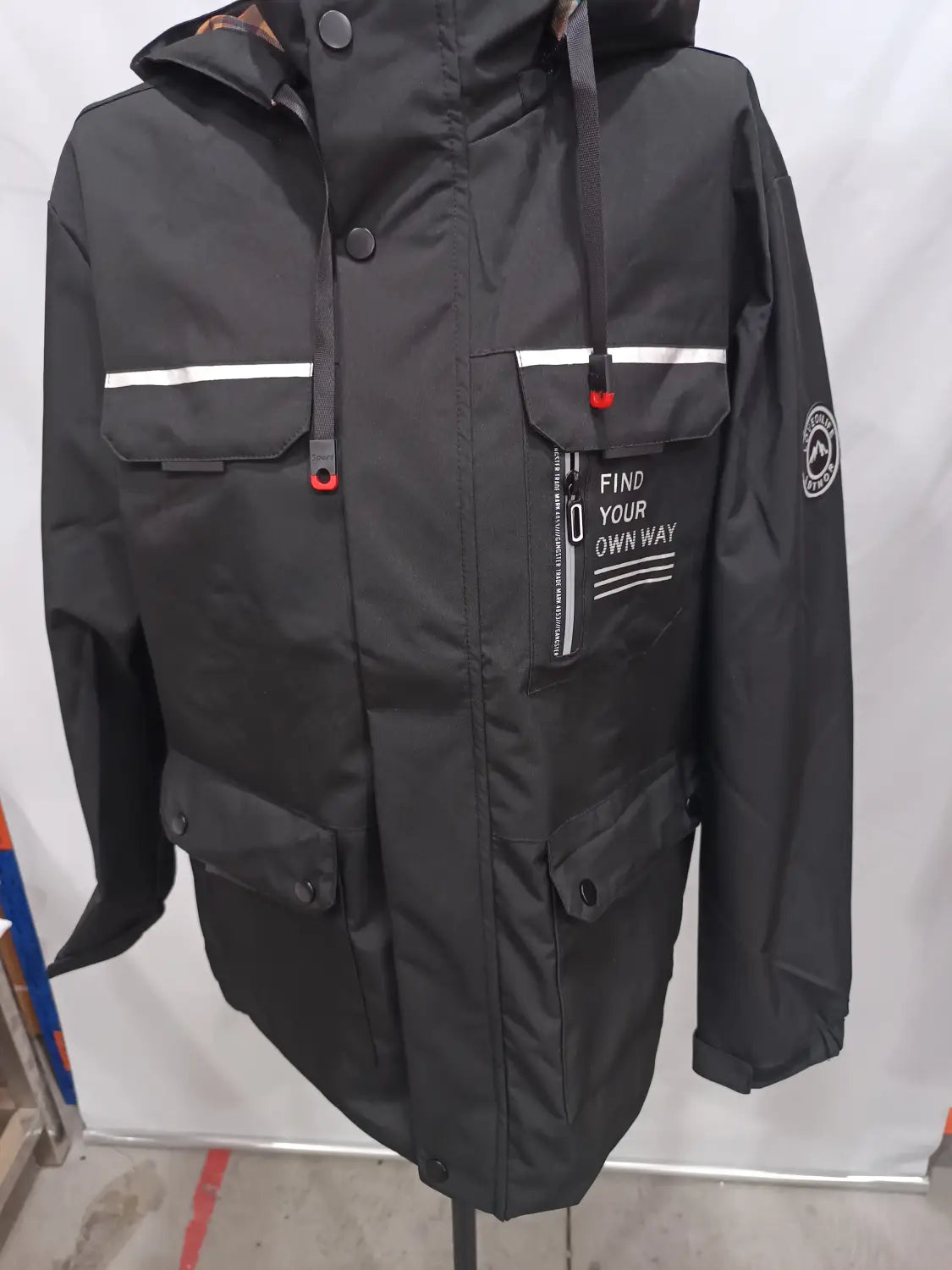 Men winter hooded parka coat in black waterproof material with white reflective stripes and red zipper pulls and button accents.