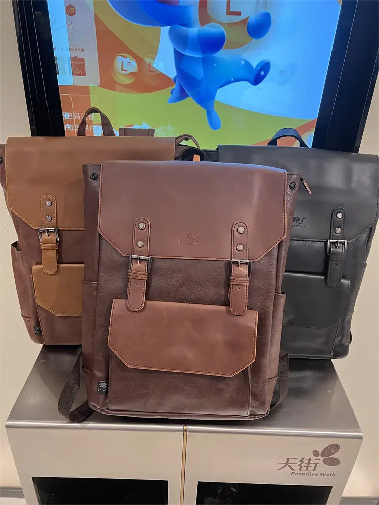 Brown leather vintage college backpack with tan and dark brown accents featuring a flap closure secured by two adjustable buckles designed for large capacity travel use.