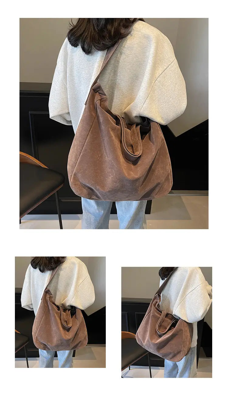 A soft taupe suede hobo bag with a slouchy oversized silhouette and matching fabric handles, styled as a large brown suede tote bag with corduroy shoulder straps.
