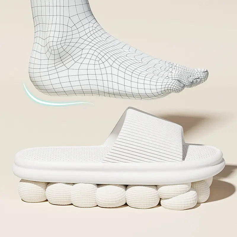 White unisex rubber slipper with textured ribbed footbed and rounded segmented soles made of anti slip EVA for house use.