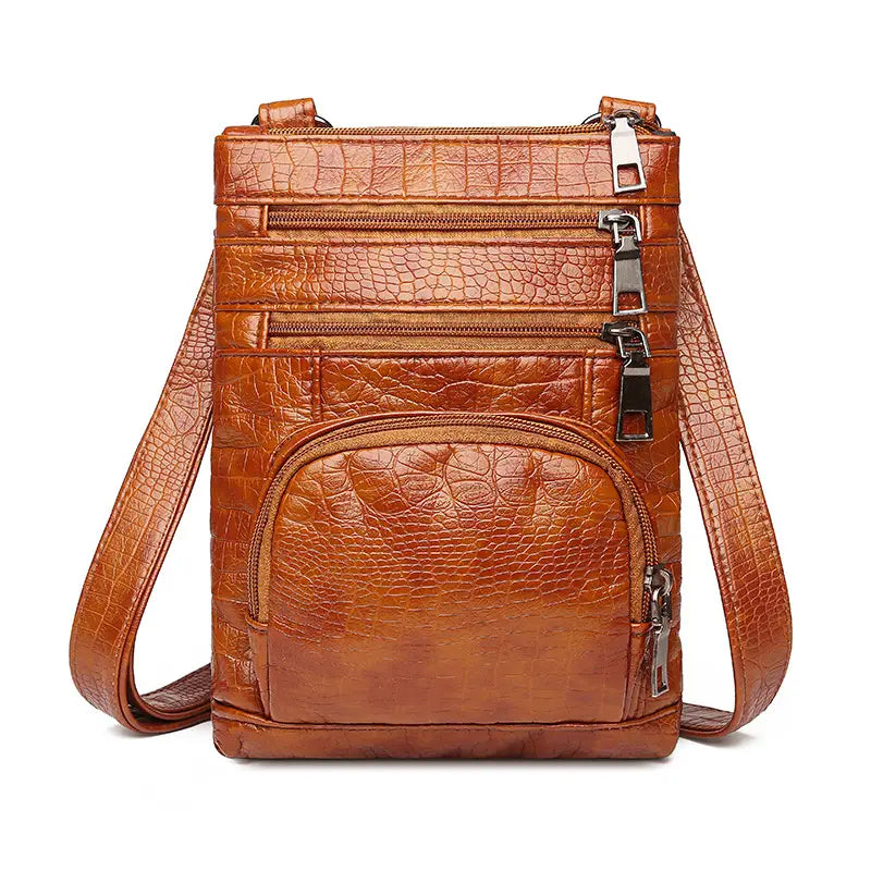 Brown retro crocodile textured soft leather crossbody bag with multiple zippers and a detachable strap.