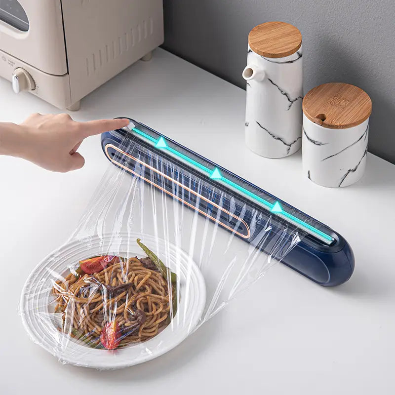 Blue plastic magnetic cling film cutter and plastic wrap dispenser with a glowing teal light strip along the top edge
