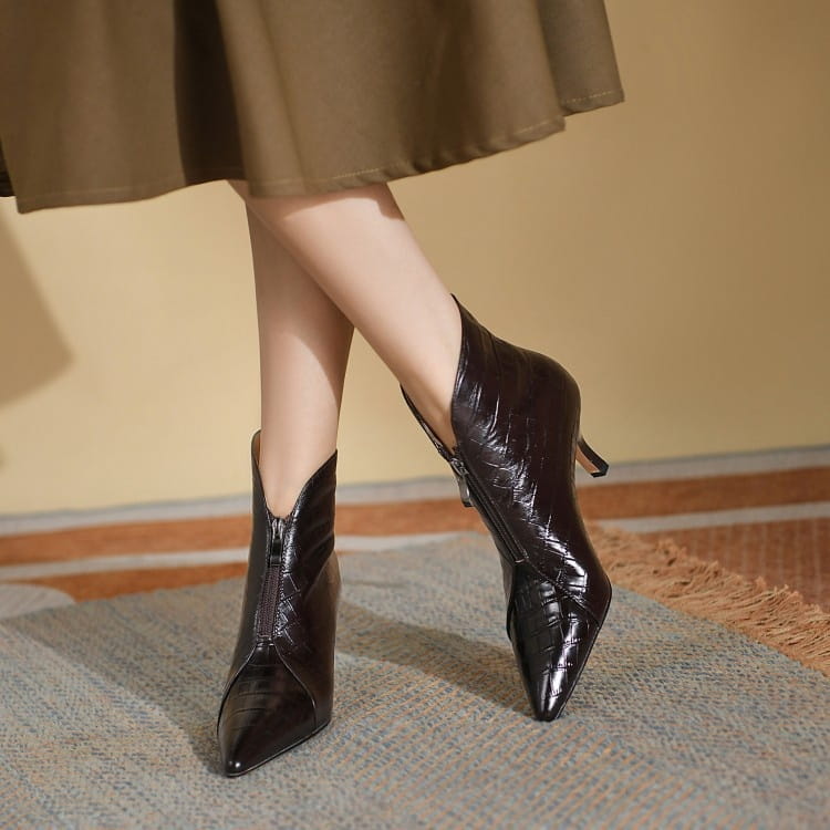Black crocodile embossed leather stiletto ankle boots featuring a pointed toe and slender heel.