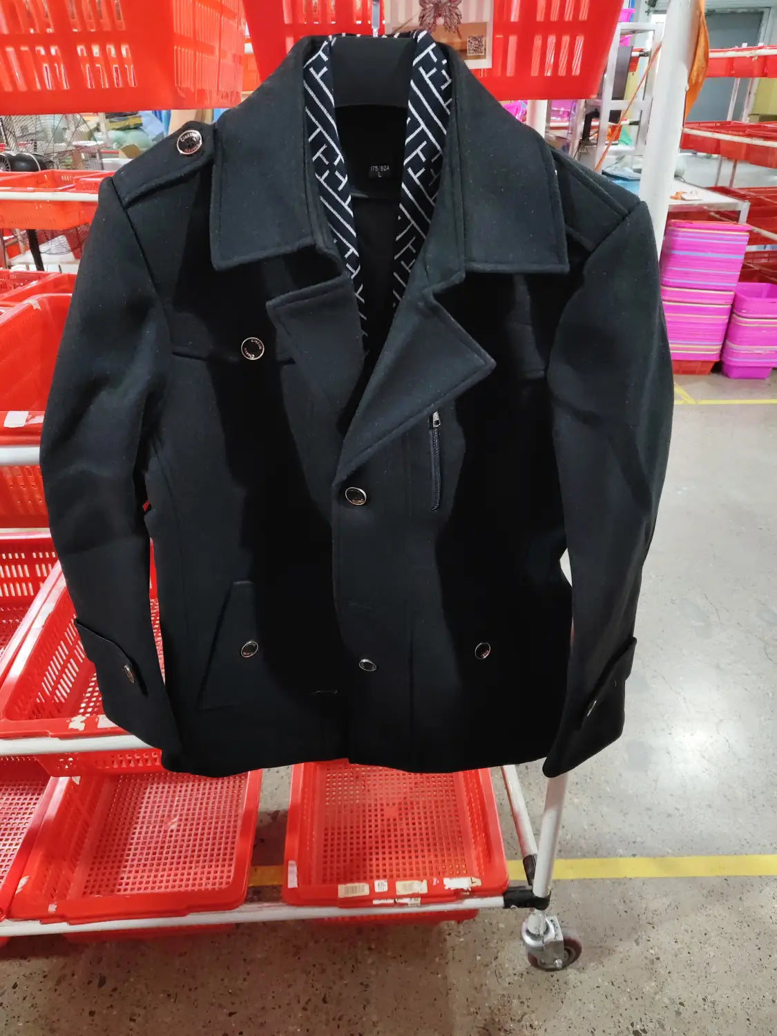 Men woolen trench coat in black featuring a double-breasted design with silver-toned buttons and a subtle striped pattern visible at the collar.