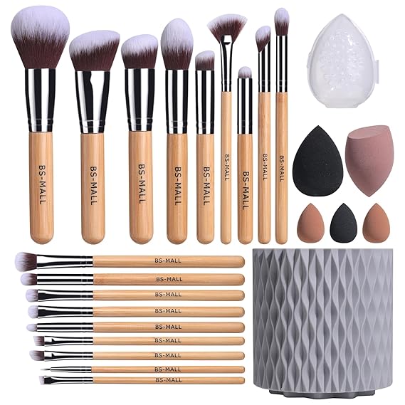 Set of 15 wooden-handled makeup brushes with silver ferrules and soft bristles accompanied by a textured gray cylindrical rotating bamboo makeup brush storage bucket.