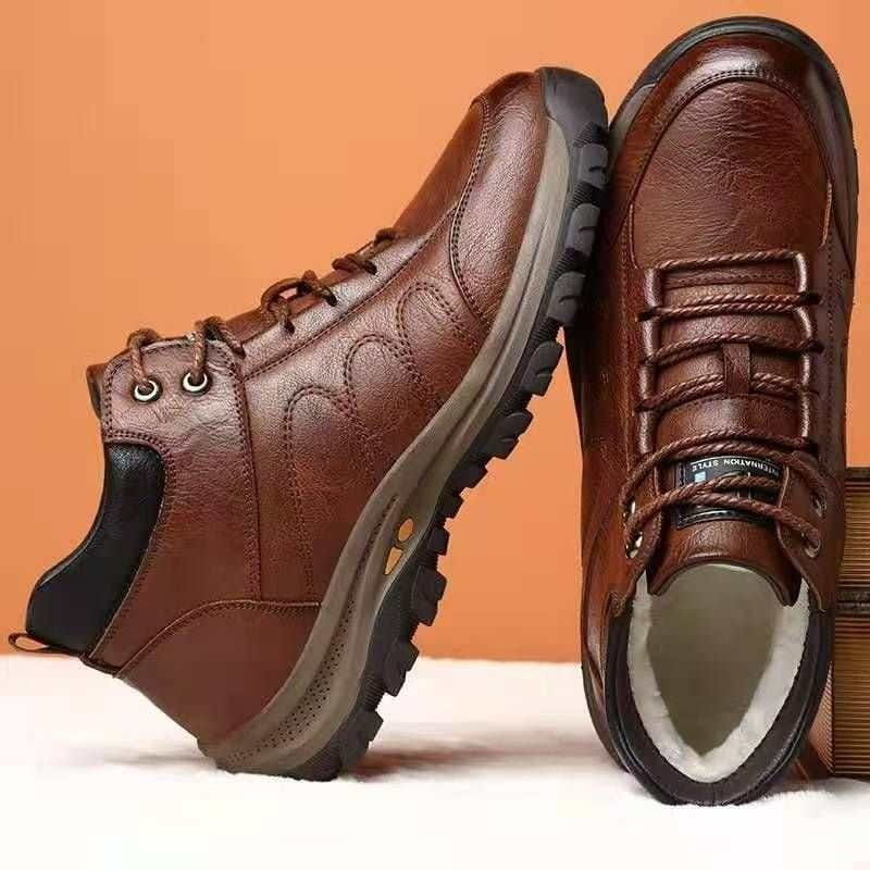 Brown leather men’s winter hiking boots with black accents and rugged sole designed for waterproof outdoor use.