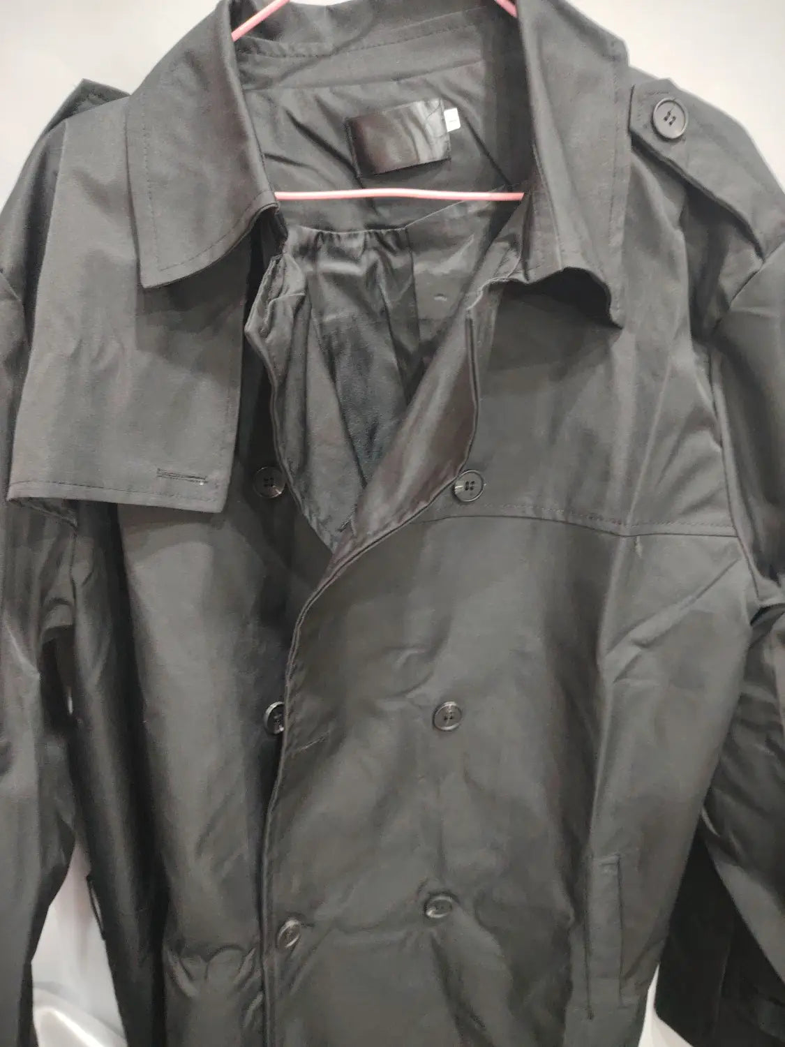 Men hooded trench coat slim double breasted jacket in black glossy fabric with dark buttons and a double breasted design.