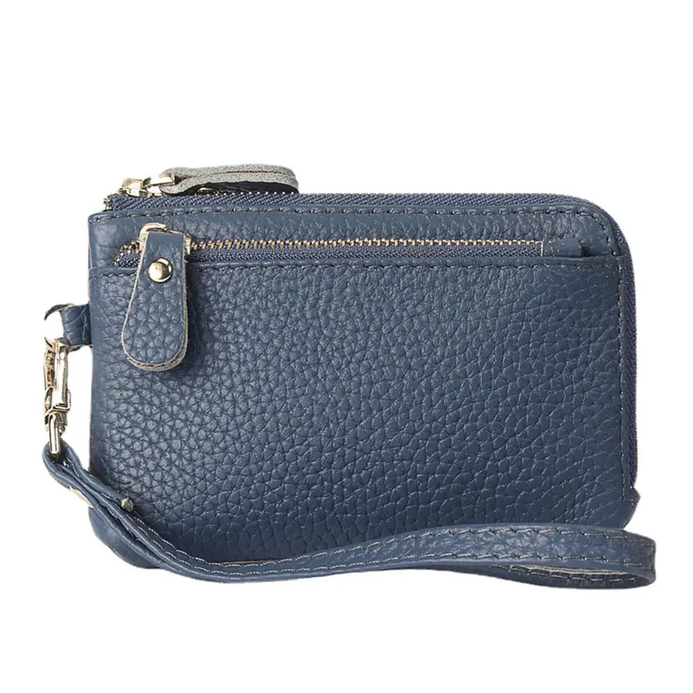 Navy blue premium textured leather wristlet wallet featuring gold hardware with zipper and metal clasp.