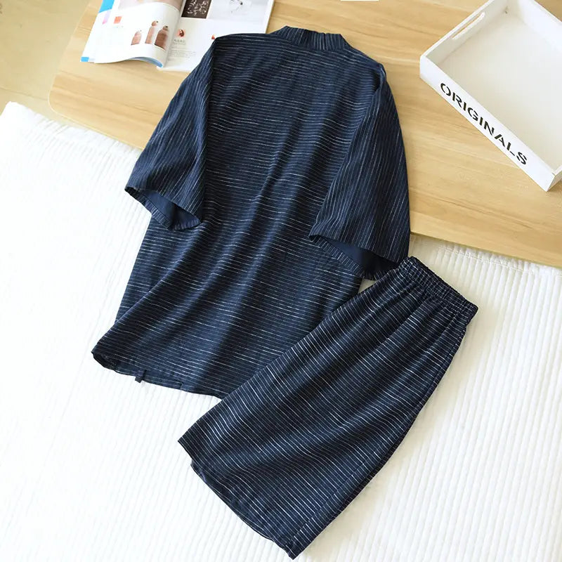 Dark blue striped cotton kimono pajama set for men featuring subtle white vertical stripes with a short-sleeved top and loose-fitting pants.