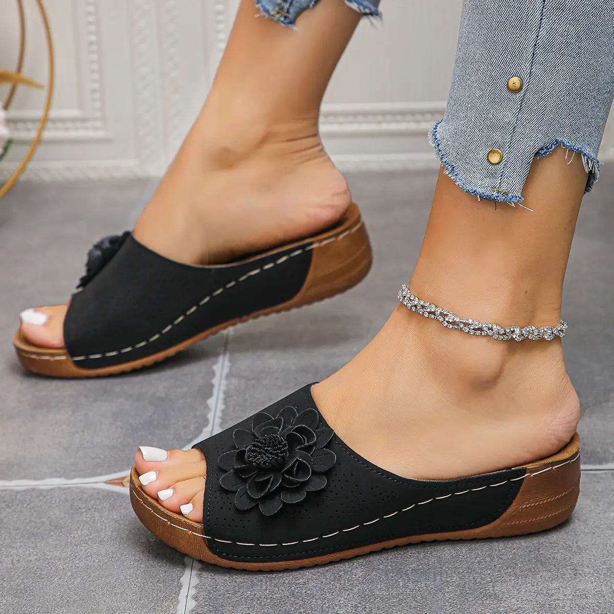 Sandalias tipo bandolera de plataforma con flores en negro, adornadas, con suelas marrones y costuras blancas, diseñadas como sandalias retro de cuero perforado para playa